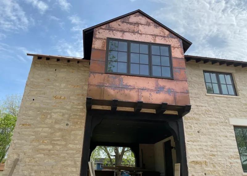 Copper metal panel facade on a stone building for Skylight Installation in Orland Hills