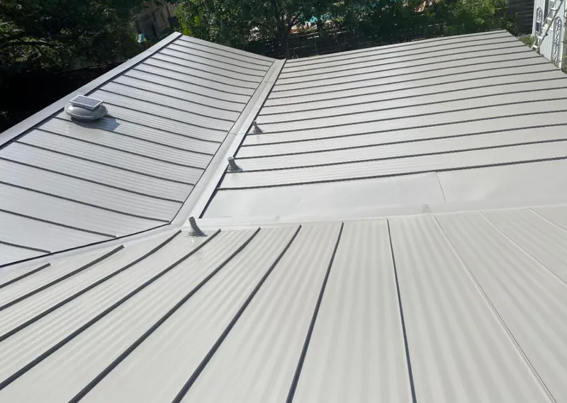 Solar attic fan installed on a metal roof for Roof Ventilation in Orland Hills